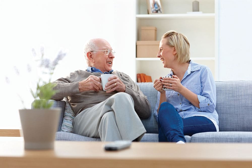 Independent Lifestyles at our Assisted Living Community Father Daughter on couch