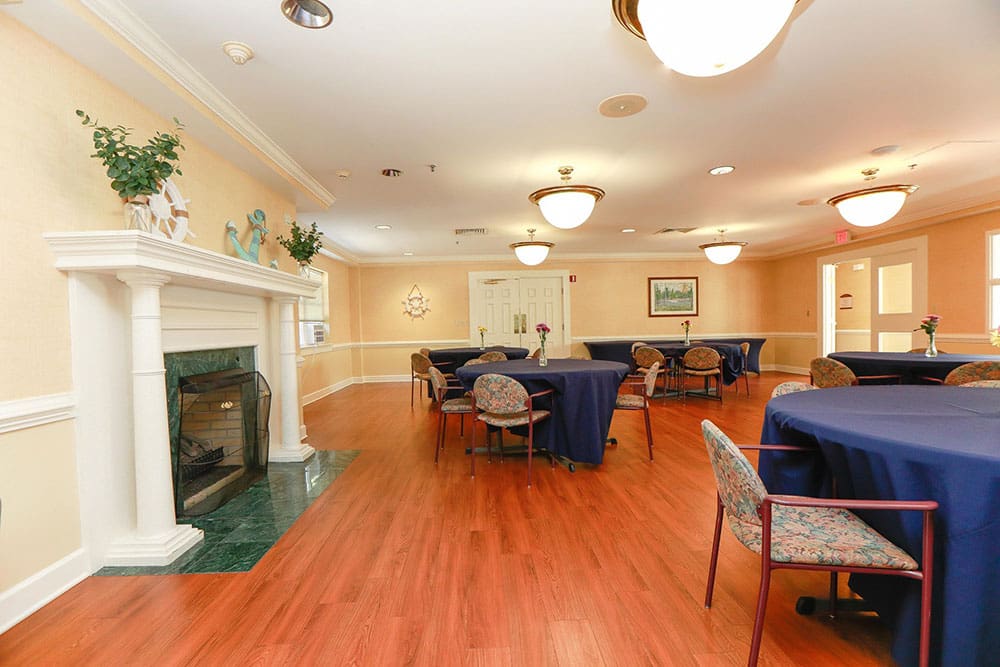 Versatile community room with fireplace for events and gatherings at Charter Senior Living of Williamsburg, VA